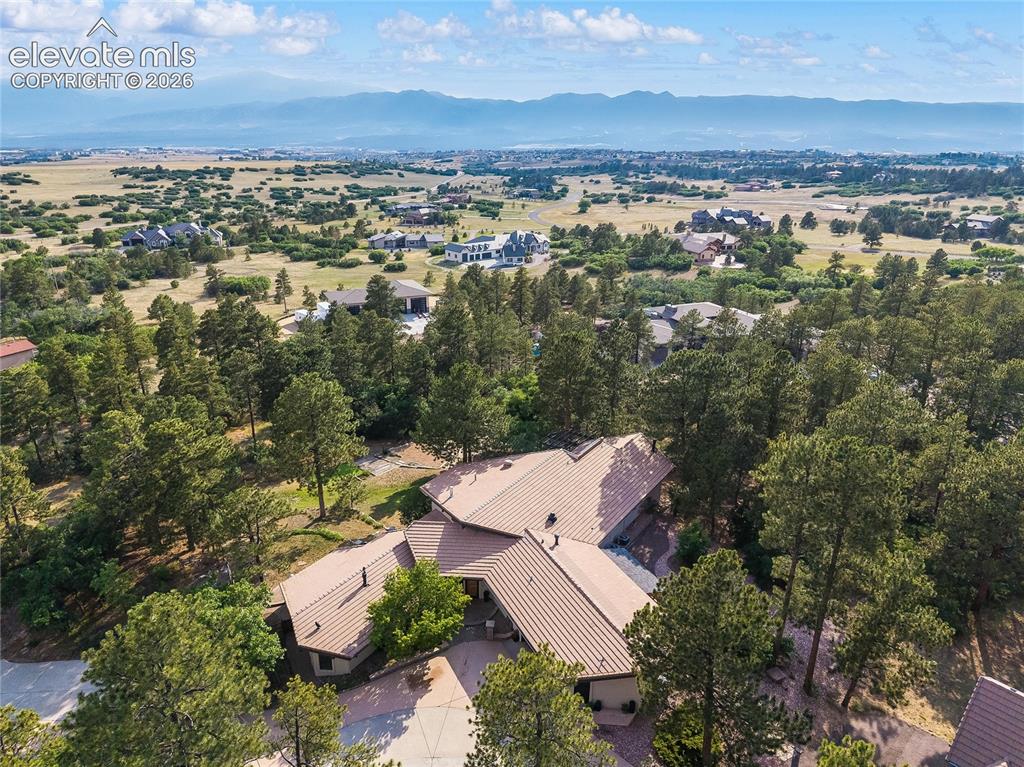 Image 47 of 50: Sprawling residential property featuring a multi-level structure with a bro