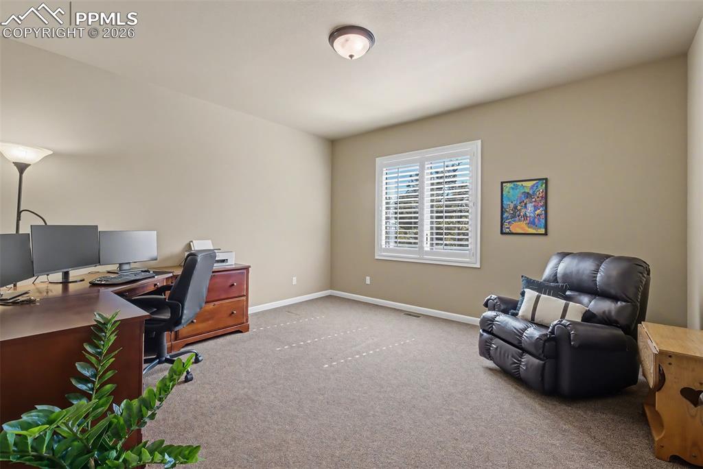 Image 33 of 45: One of 4 main level bedrooms. Adjacent to a 3/4 bathroom