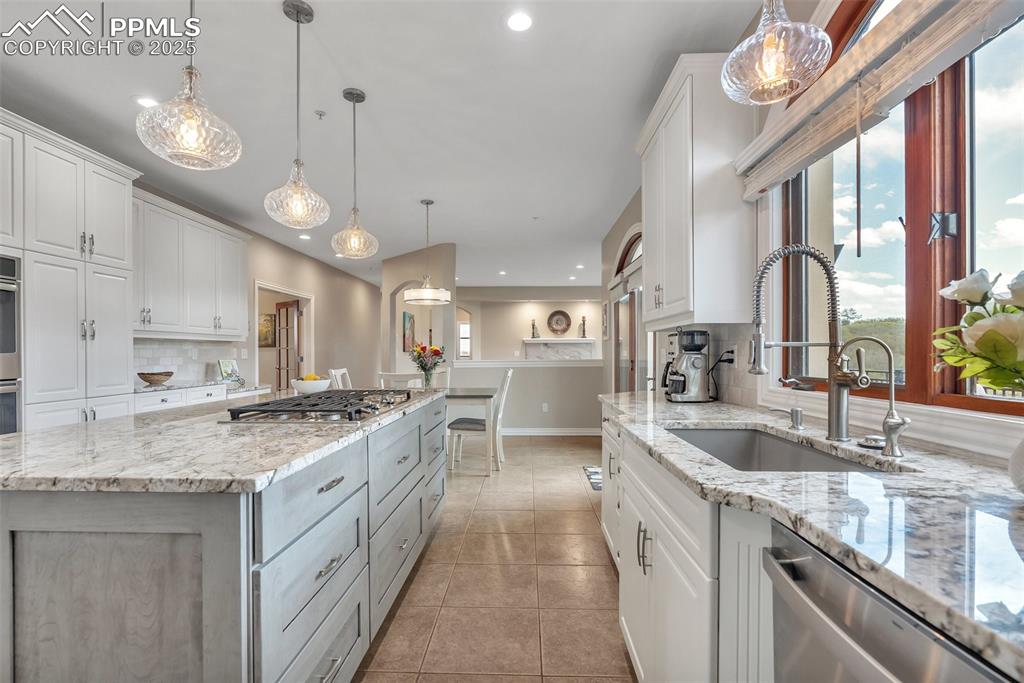Image 11 of 49: Kitchen featuring appliances with stainless steel finishes, a sink, recesse
