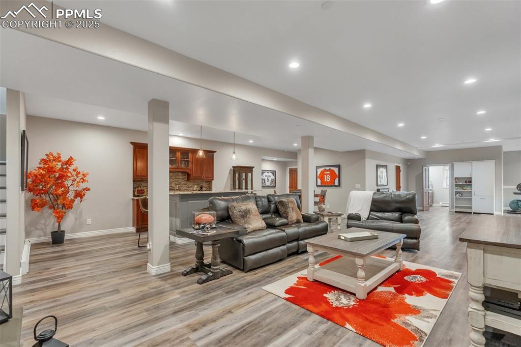 Image 15 of 49: Living area featuring light wood-style flooring, recessed lighting, baseboa