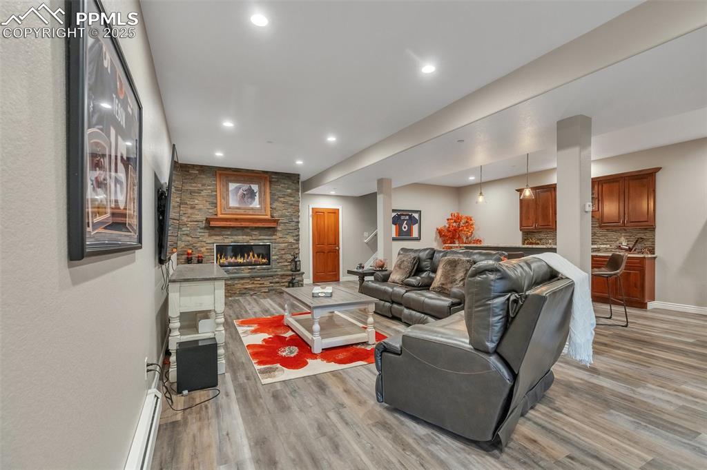 Image 16 of 49: Living area featuring light wood-type flooring, recessed lighting, baseboar