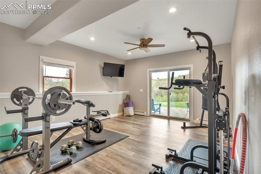 Image 18 of 49: Exercise area featuring healthy amount of natural light, a baseboard radiat