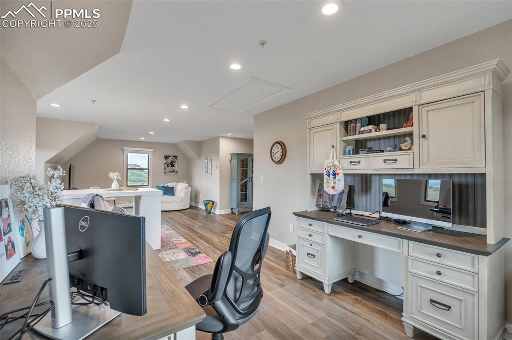 Image 35 of 49: Office featuring attic access, light wood finished floors, built in study a