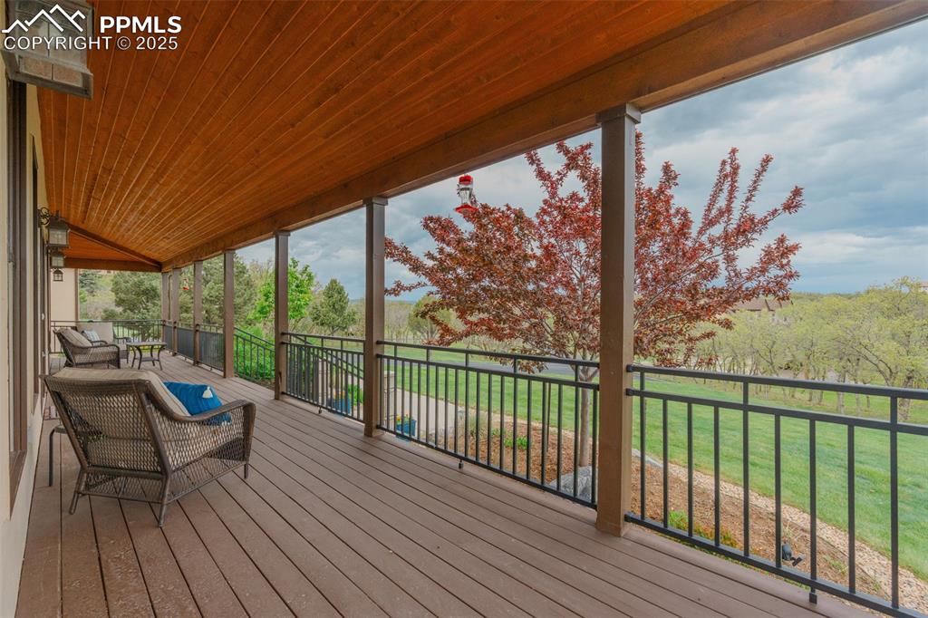 Image 38 of 49: Wooden terrace with a yard