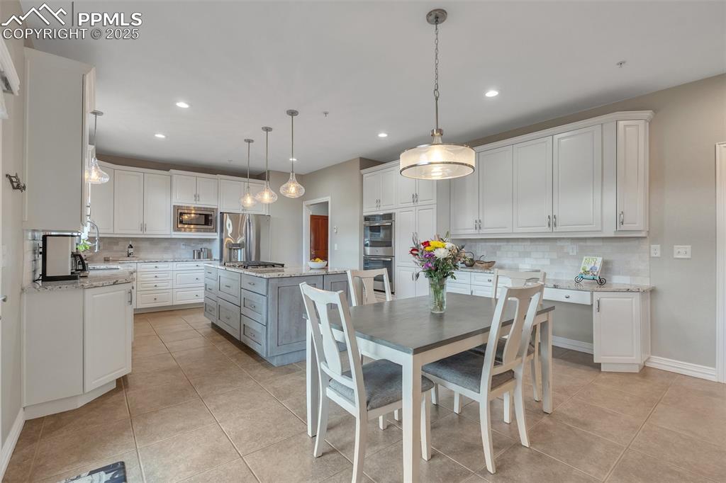 Image 9 of 49: Dining area featuring light tile patterned floors, recessed lighting, and b