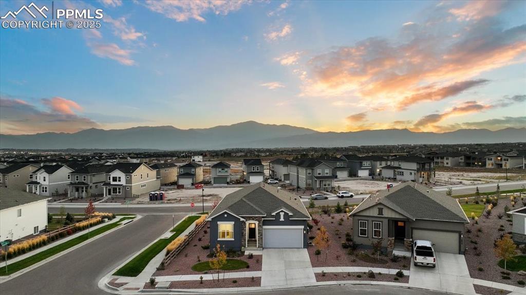 Image 2 of 31: Aerial view of residential area featuring a mountainous background