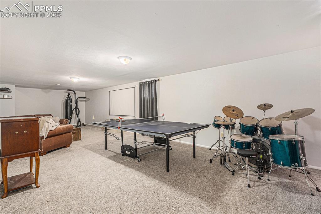 Image 17 of 28: Basement living room with newer carpet