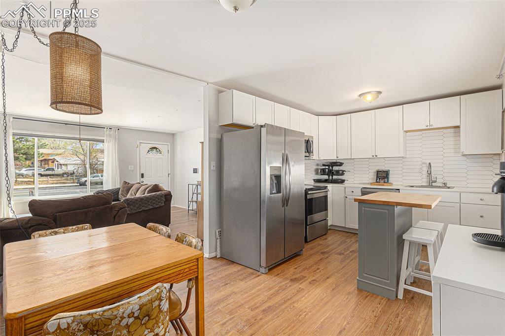 Image 6 of 28: Updated kitchen with stainless steel appliances and center island.