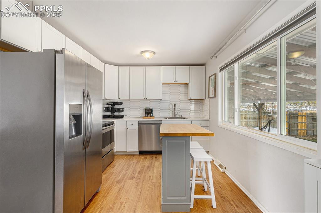 Image 7 of 28: Updated kitchen with stainless steel appliances and center island.