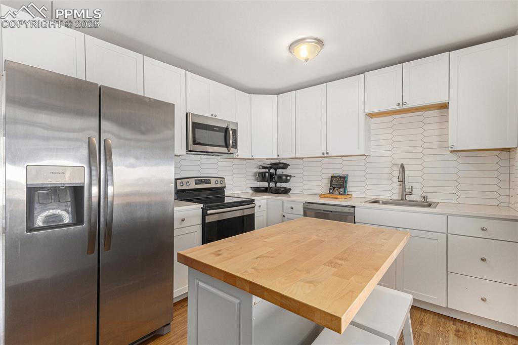 Image 8 of 28: Updated kitchen with stainless steel appliances and center island.