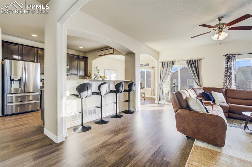 Image 6 of 49: Living room & counter seating off the kitchen. 