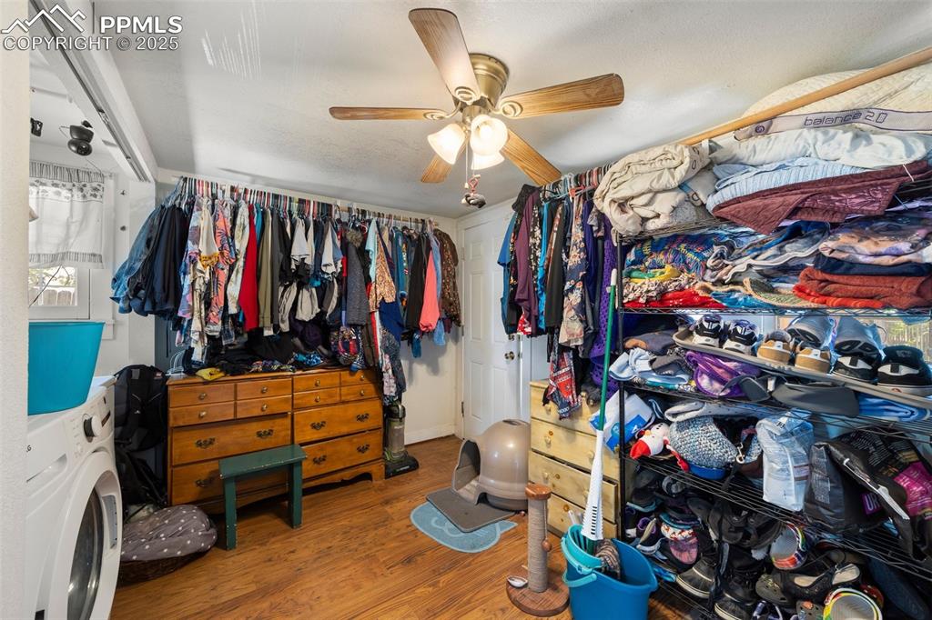 Image 14 of 31: Walk in closet featuring washer / clothes dryer, wood finished floors, and