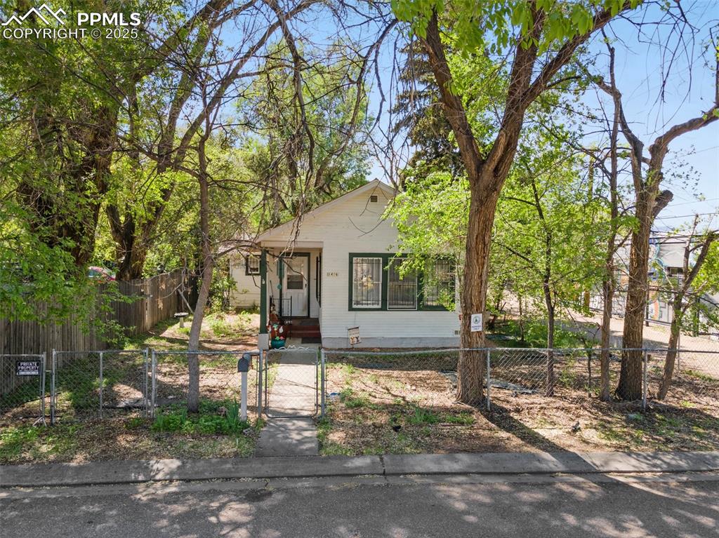 Image 6 of 31: Bungalow with a gate and a fenced front yard