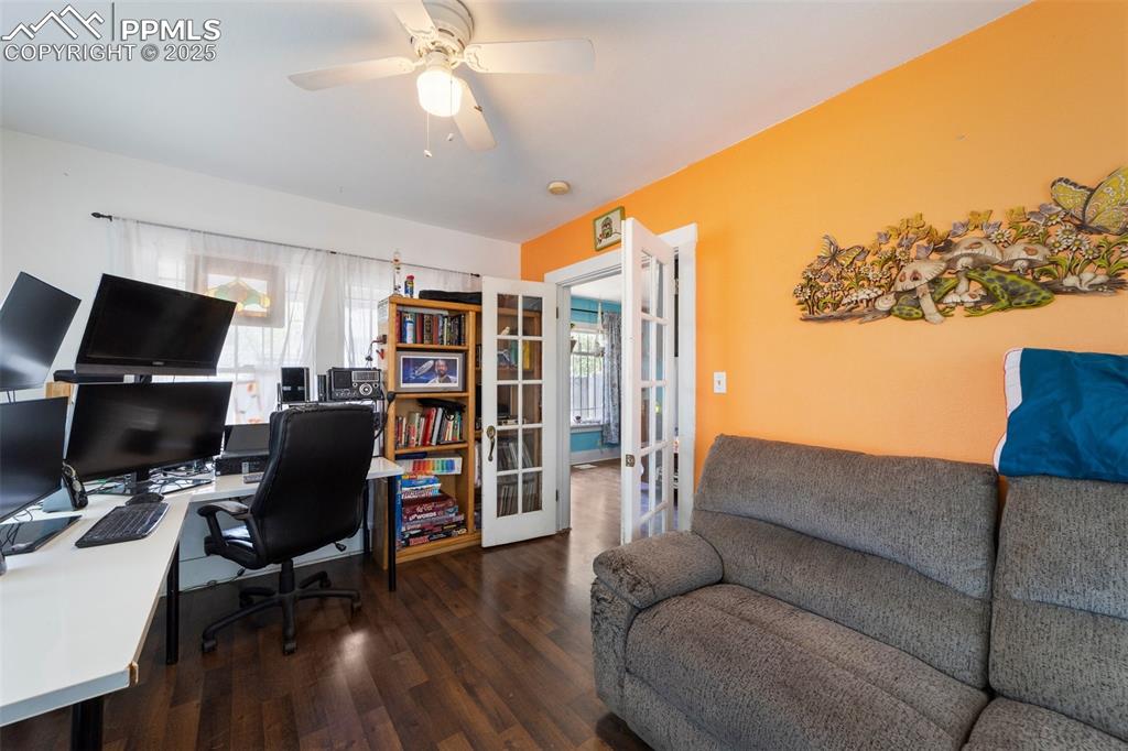 Image 7 of 31: Office space with french doors, wood finished floors, and ceiling fan
