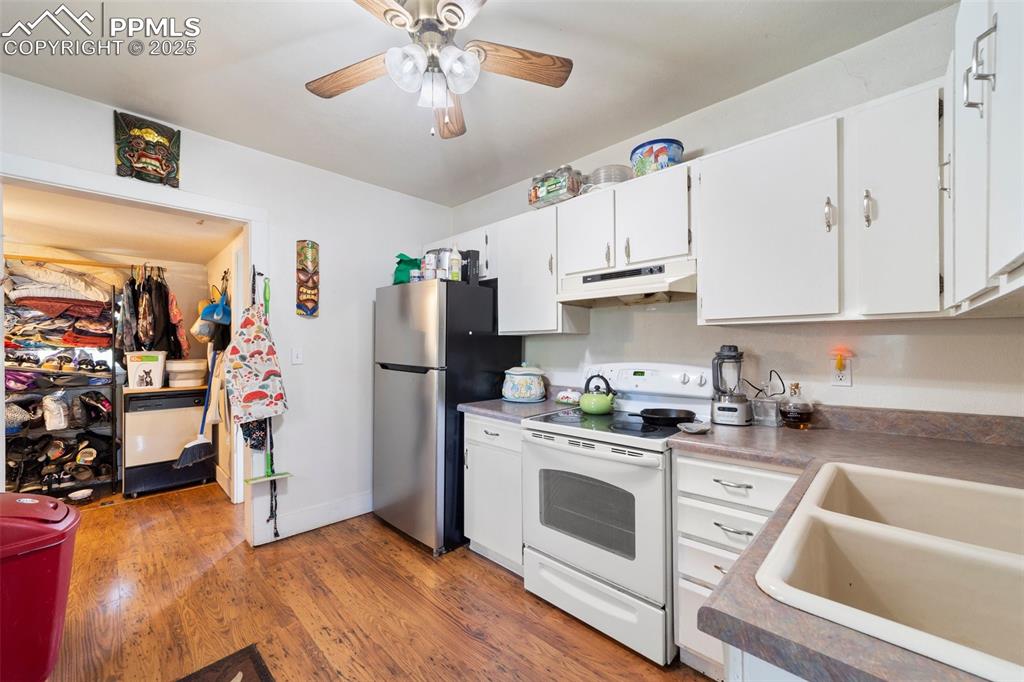 Image 8 of 31: Office space with french doors, wood finished floors, and ceiling fan