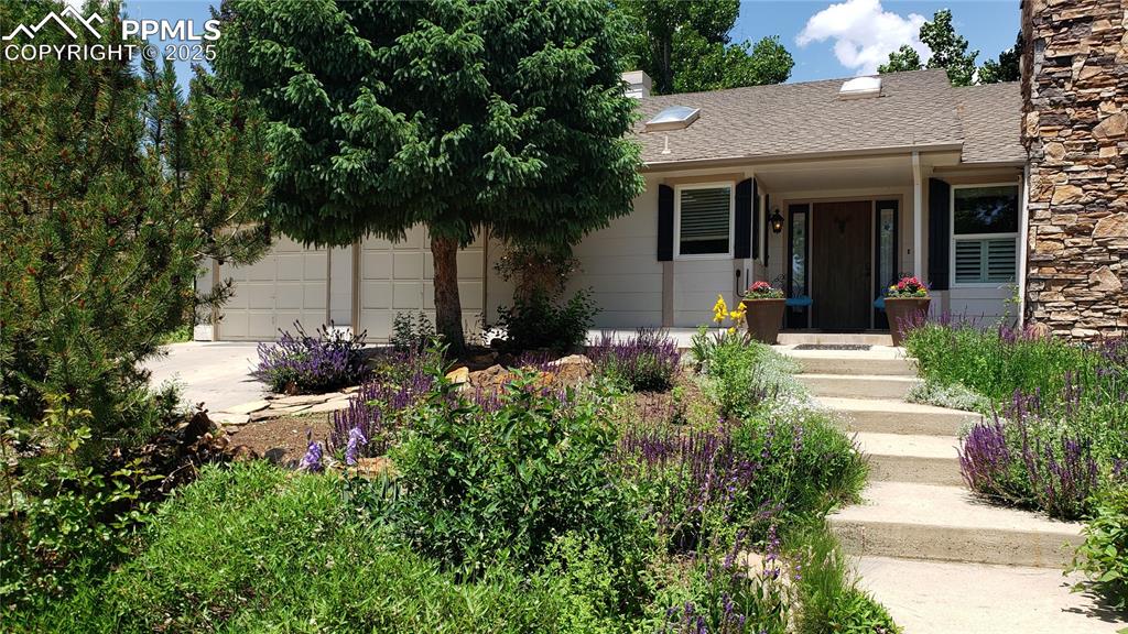 Image 4 of 49: Charming country garden look to the front door!