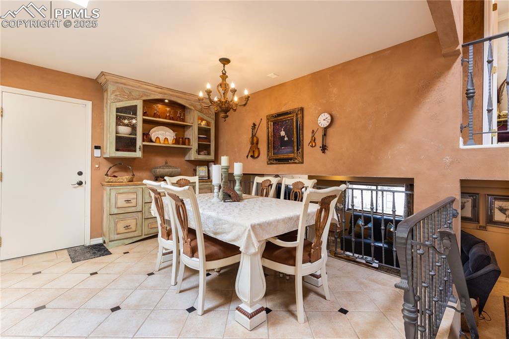Image 9 of 49: Open dining room on the main level with built-in buffet cabinet