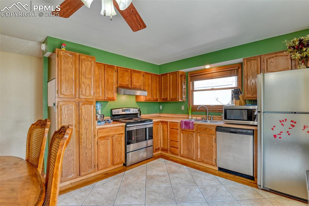 Image 10 of 32: Kitchen featuring appliances with stainless steel finishes, light counterto