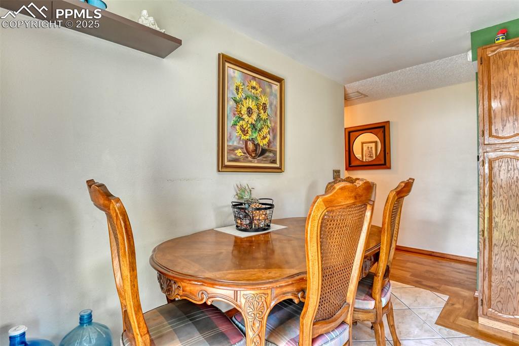 Image 11 of 32: Dining space with light tile patterned flooring