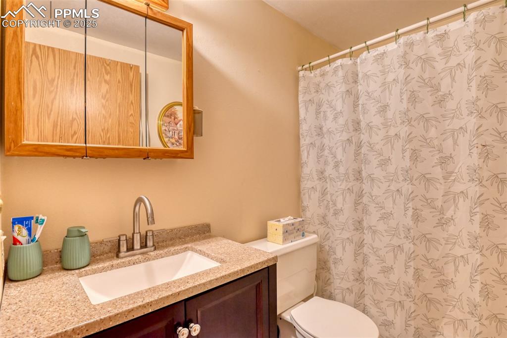 Image 29 of 32: Full bathroom featuring vanity and a shower with curtain
