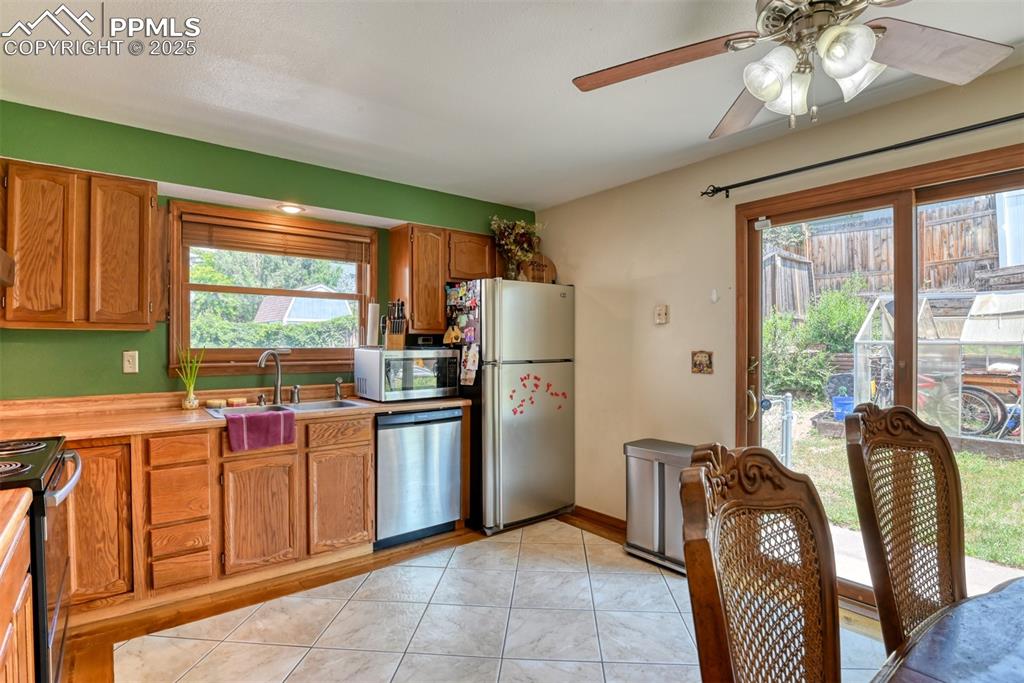 Image 7 of 32: Kitchen featuring stainless steel appliances, light countertops, ceiling fa
