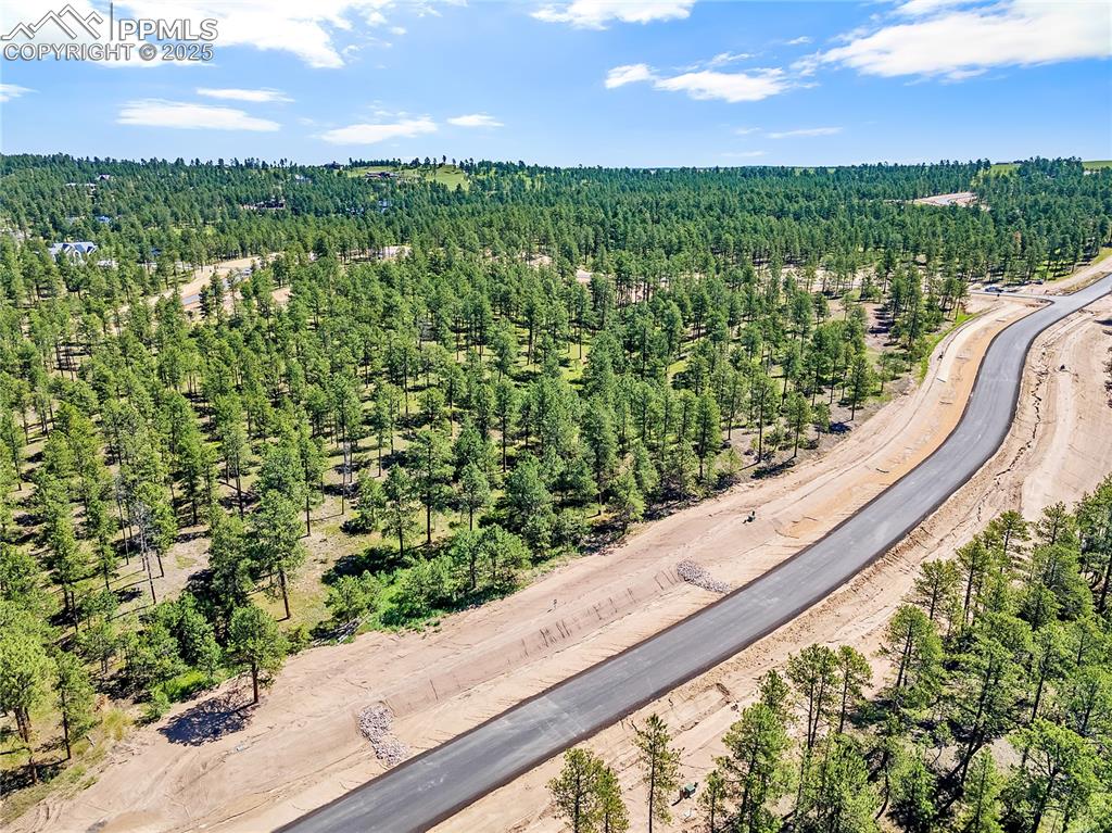 Image 3 of 8: Drone / aerial view of a heavily wooded area