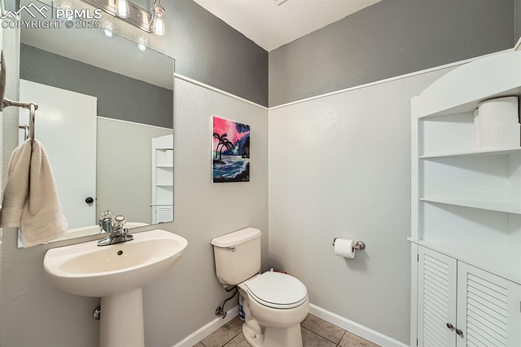 Image 10 of 28: Bathroom featuring toilet and tile patterned flooring