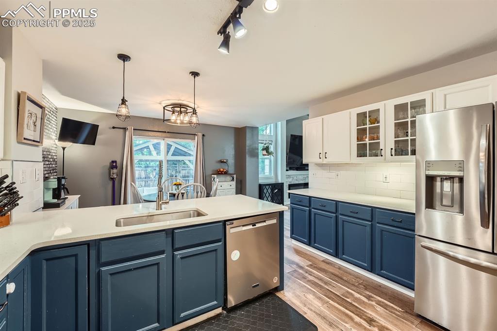 Image 9 of 28: Kitchen featuring appliances with stainless steel finishes, blue cabinets, 