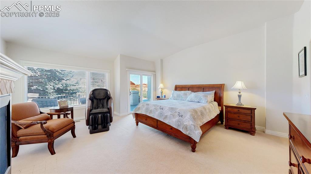 Image 15 of 46: Bedroom with light carpet, access to exterior, and lofted ceiling