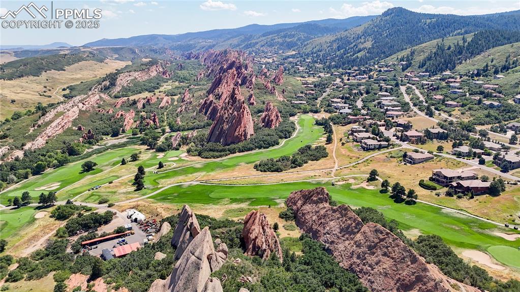 Image 2 of 46: Aerial view of a mountainous background and a local golf course