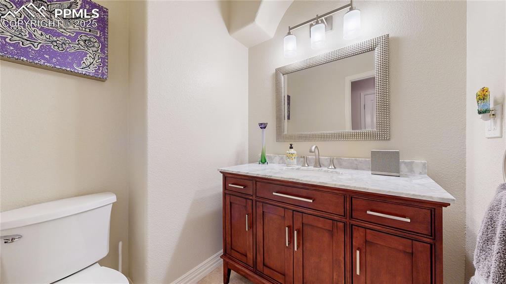 Image 21 of 46: Half bath featuring vanity and a textured wall