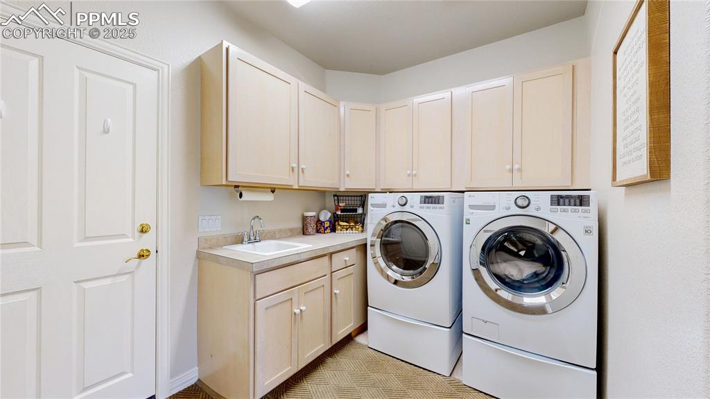 Image 22 of 46: Laundry room with washer and dryer and cabinet space