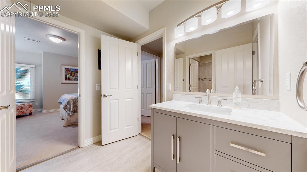 Image 29 of 46: Ensuite bathroom featuring vanity and light wood finished floors
