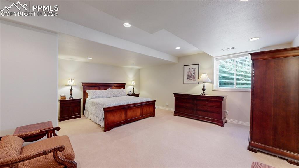 Image 31 of 46: Bedroom with recessed lighting and light carpet