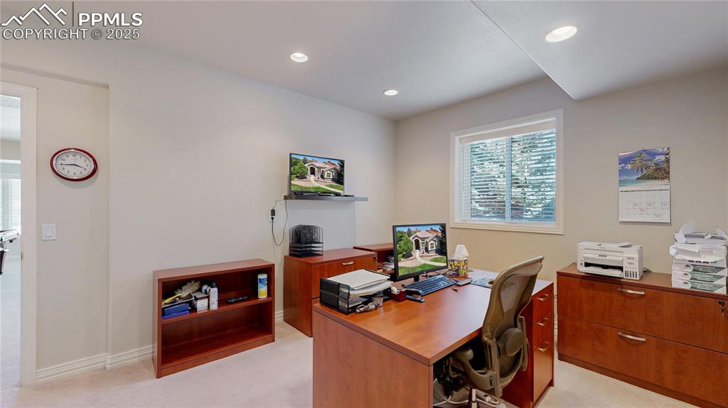 Image 32 of 46: Office area with recessed lighting and light carpet