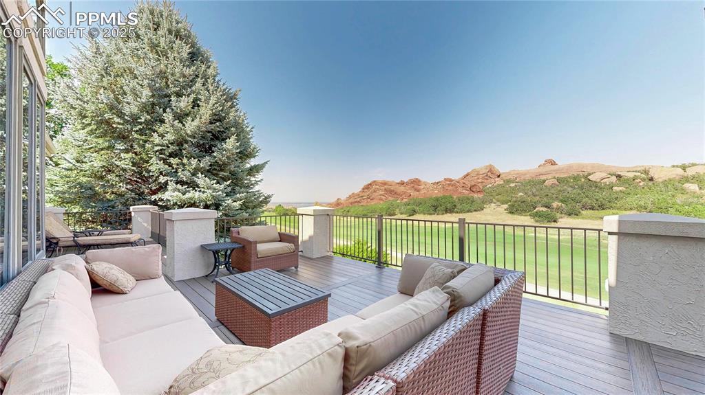 Image 35 of 46: Deck with an outdoor living space and a yard