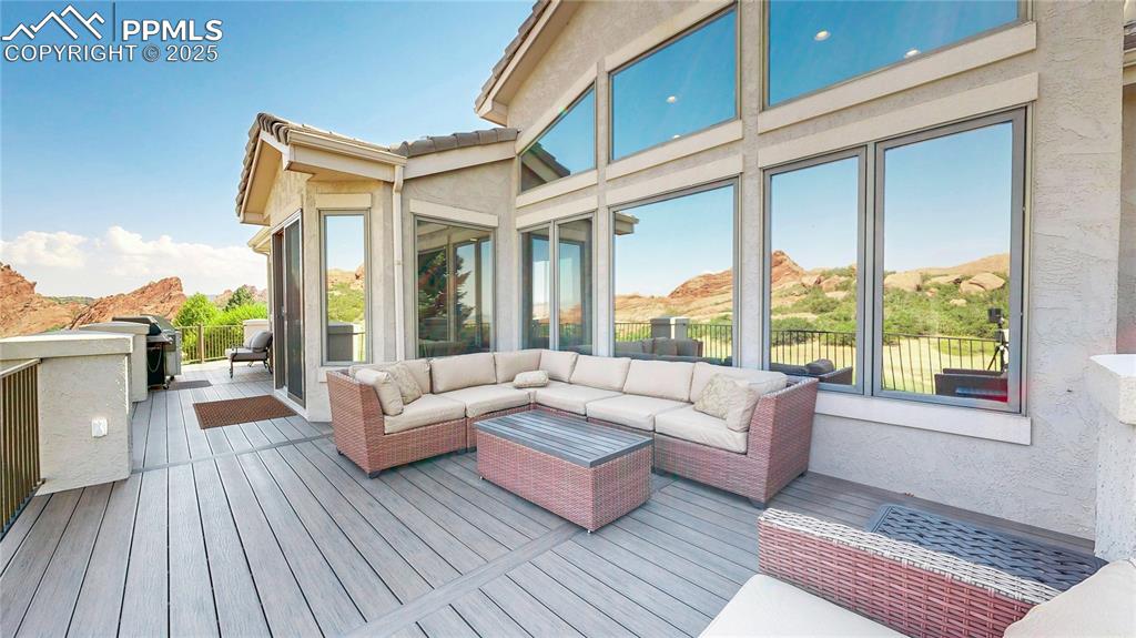 Image 36 of 46: Deck with a mountain view, an outdoor living space, and area for grilling