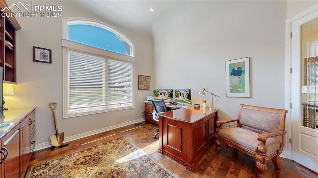 Image 4 of 46: Home office featuring dark wood-style floors