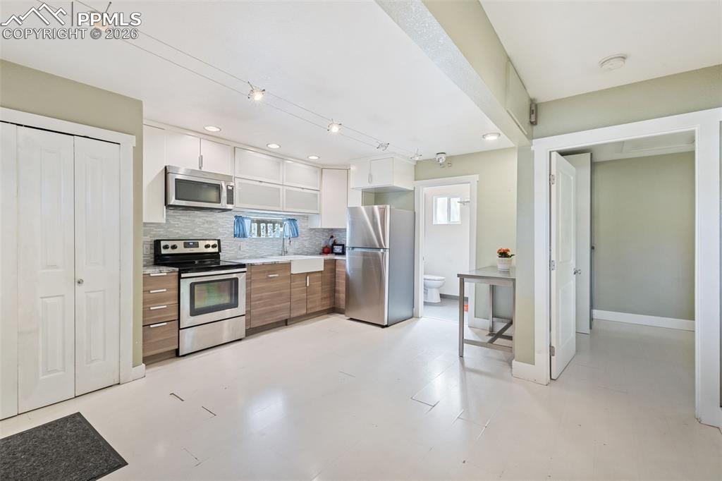 Image 5 of 35: Laundry Space Conveniently Located and Tucked Away Behind Charming Doors!
