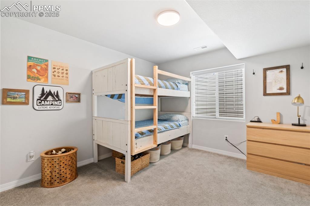 Image 19 of 22: Bedroom with carpet floors and baseboards
