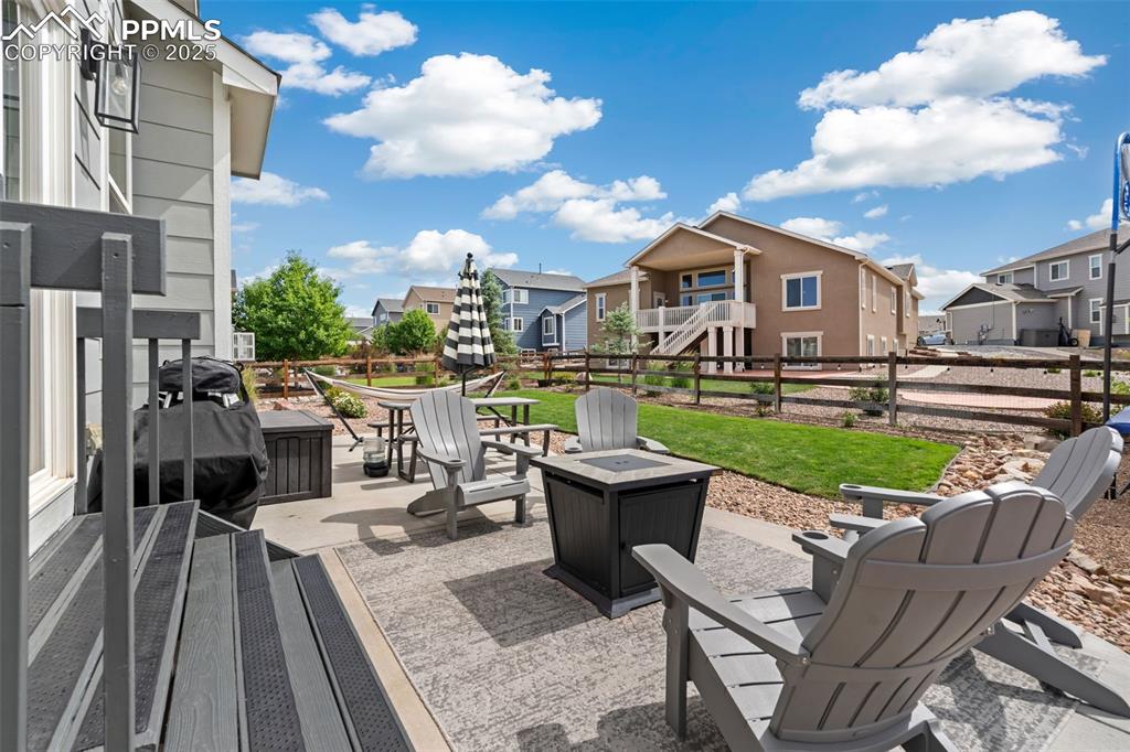 Image 21 of 22: View of patio / terrace with a residential view, an outdoor fire pit, and a