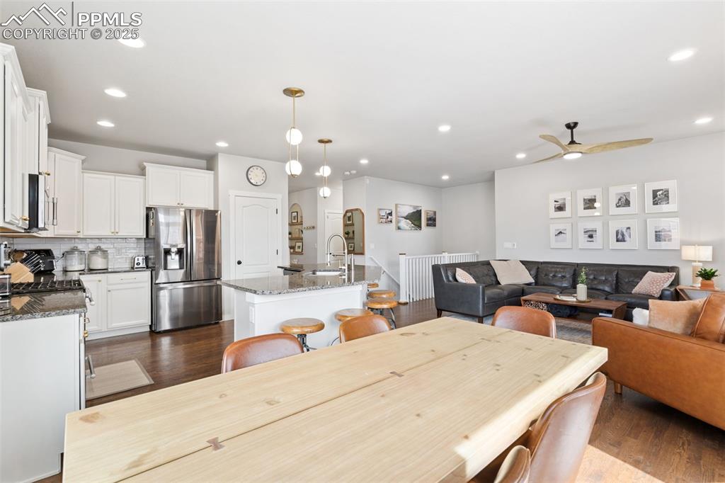 Image 6 of 22: Dining room featuring dark wood-style floors, a ceiling fan, and recessed l