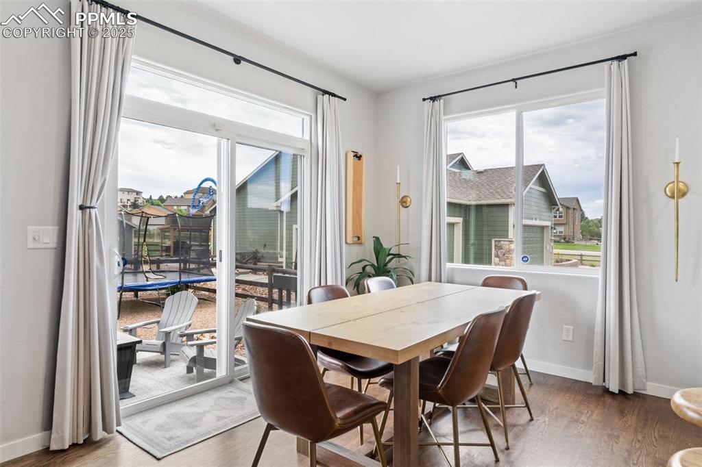 Image 7 of 22: Dining room with wood finished floors and baseboards