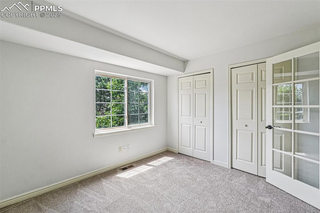 Image 24 of 46: Unfurnished bedroom featuring two closets and carpet floors