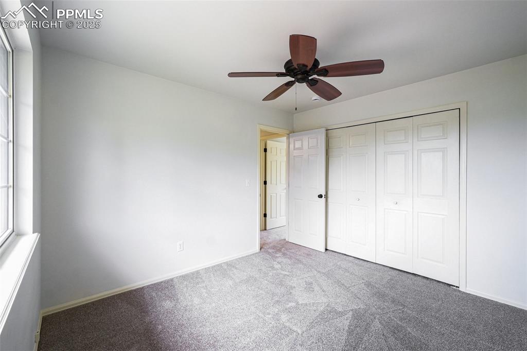 Image 29 of 46: Unfurnished bedroom featuring carpet, a closet, and a ceiling fan
