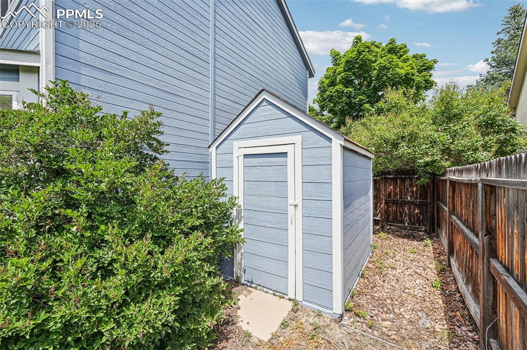 Image 42 of 46: View of shed with a fenced backyard