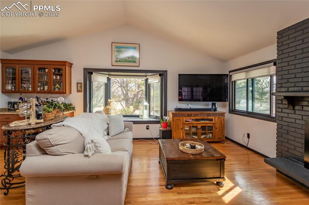 Image 13 of 50: Dry bar with wine fridge in the left corner.
