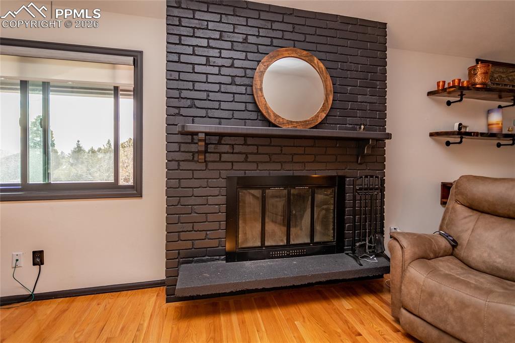 Image 15 of 50: Cozy wood burning fireplace.