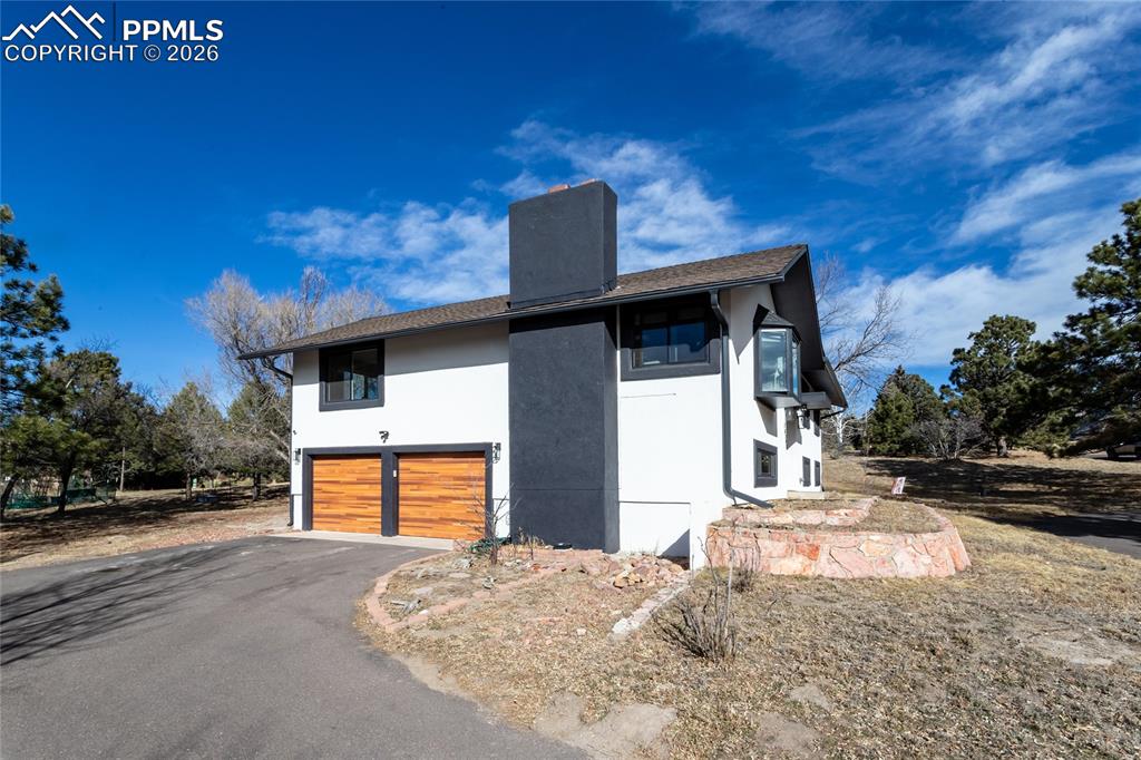 Image 3 of 50: Expansive driveways leads to oversized garage.