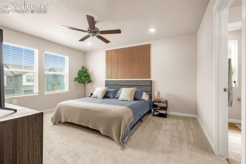 Image 11 of 35: Bedroom featuring light colored carpet, ceiling fan, recessed lighting, and